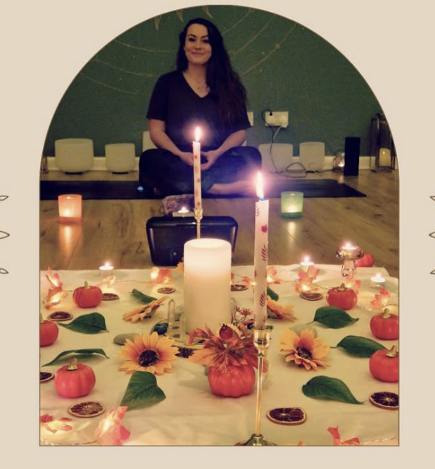 Candlelit yoga and meditation studio setting with seasonal altar decor