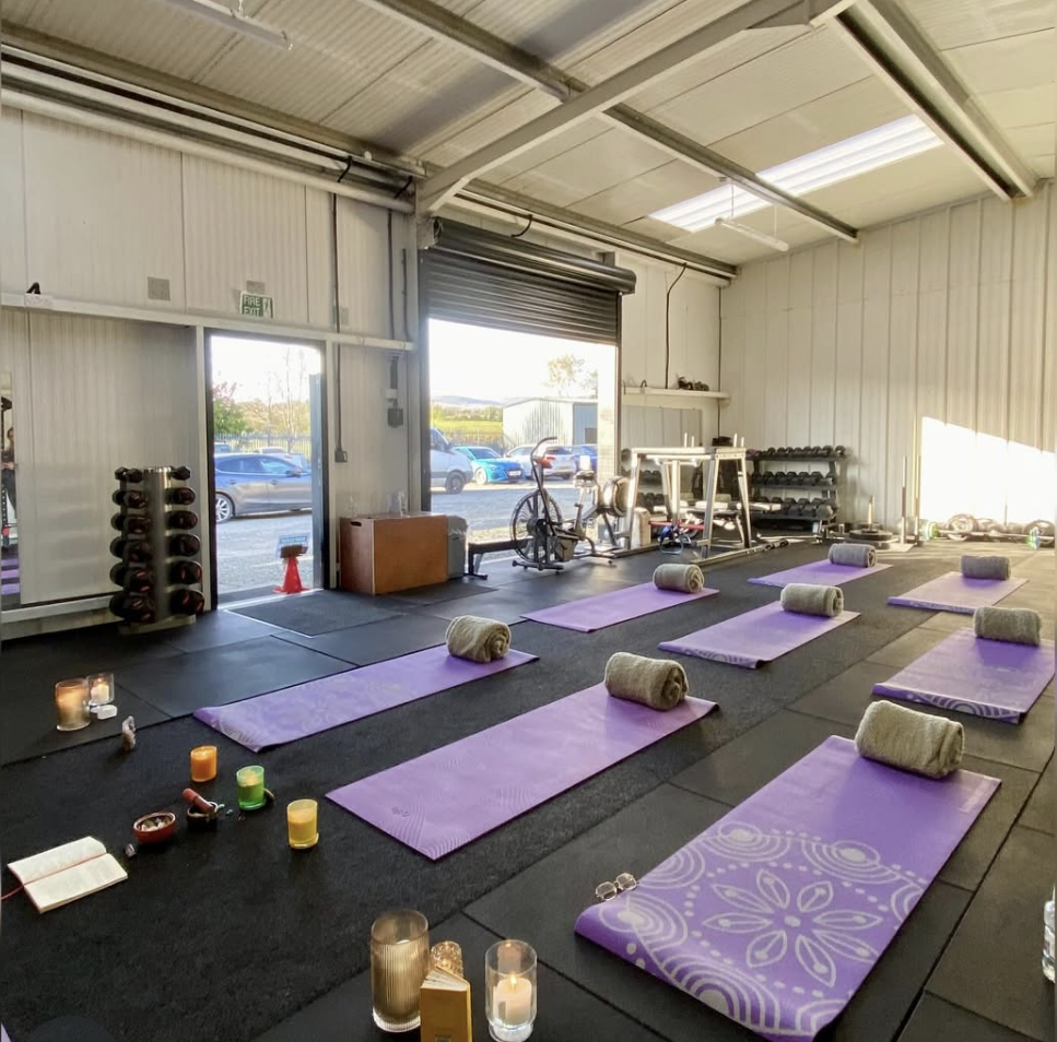 Group retreat space prepared with yoga mats, blankets and candles